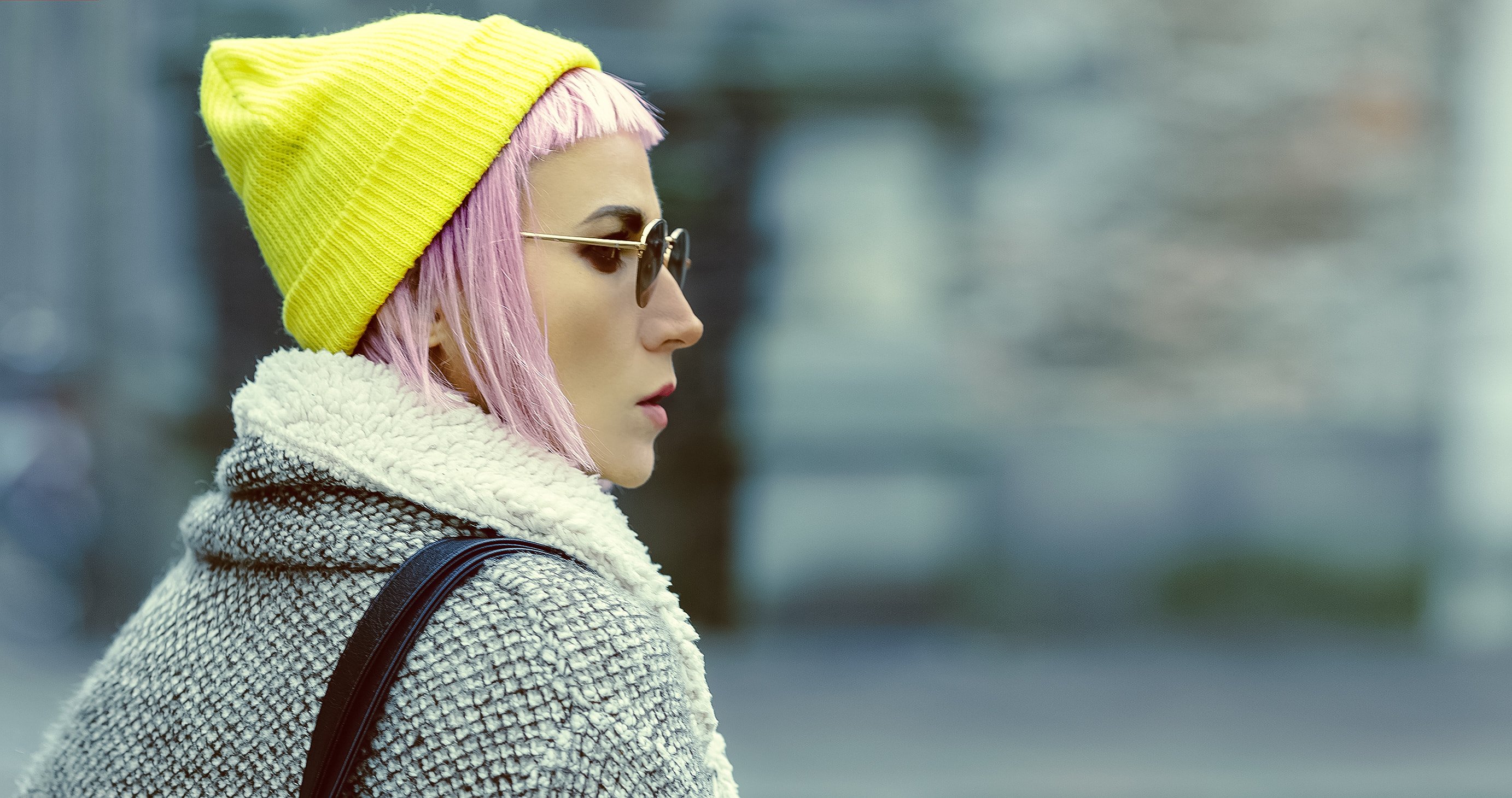 Stylish girl with pink hair on the street. urban fashion