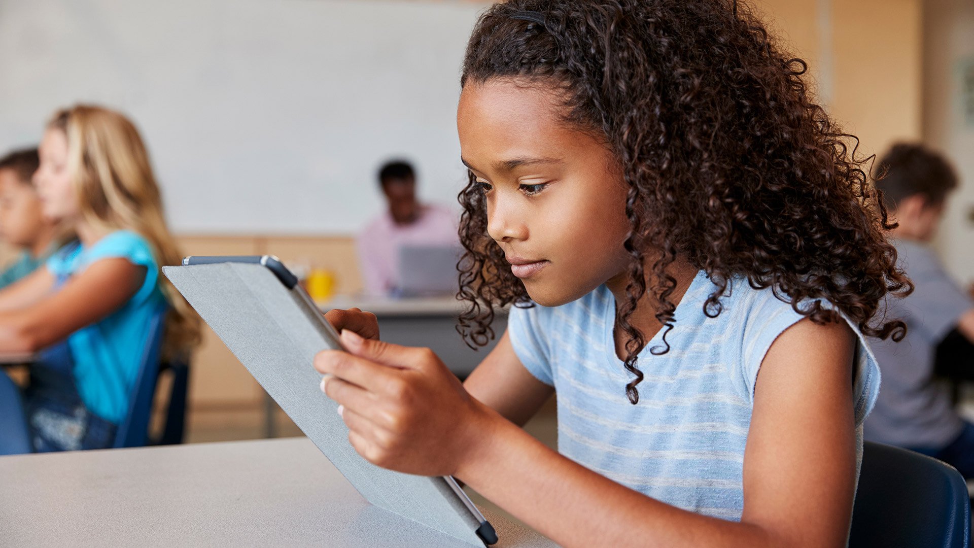 School-Girl-Using-Tablet-in-Elementary-School-Class-Close-up