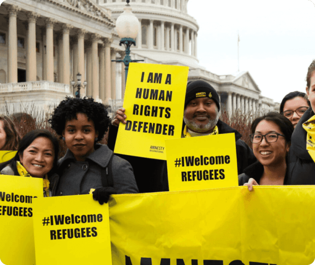 A photo of people in amnesy protesting for refugee rights 