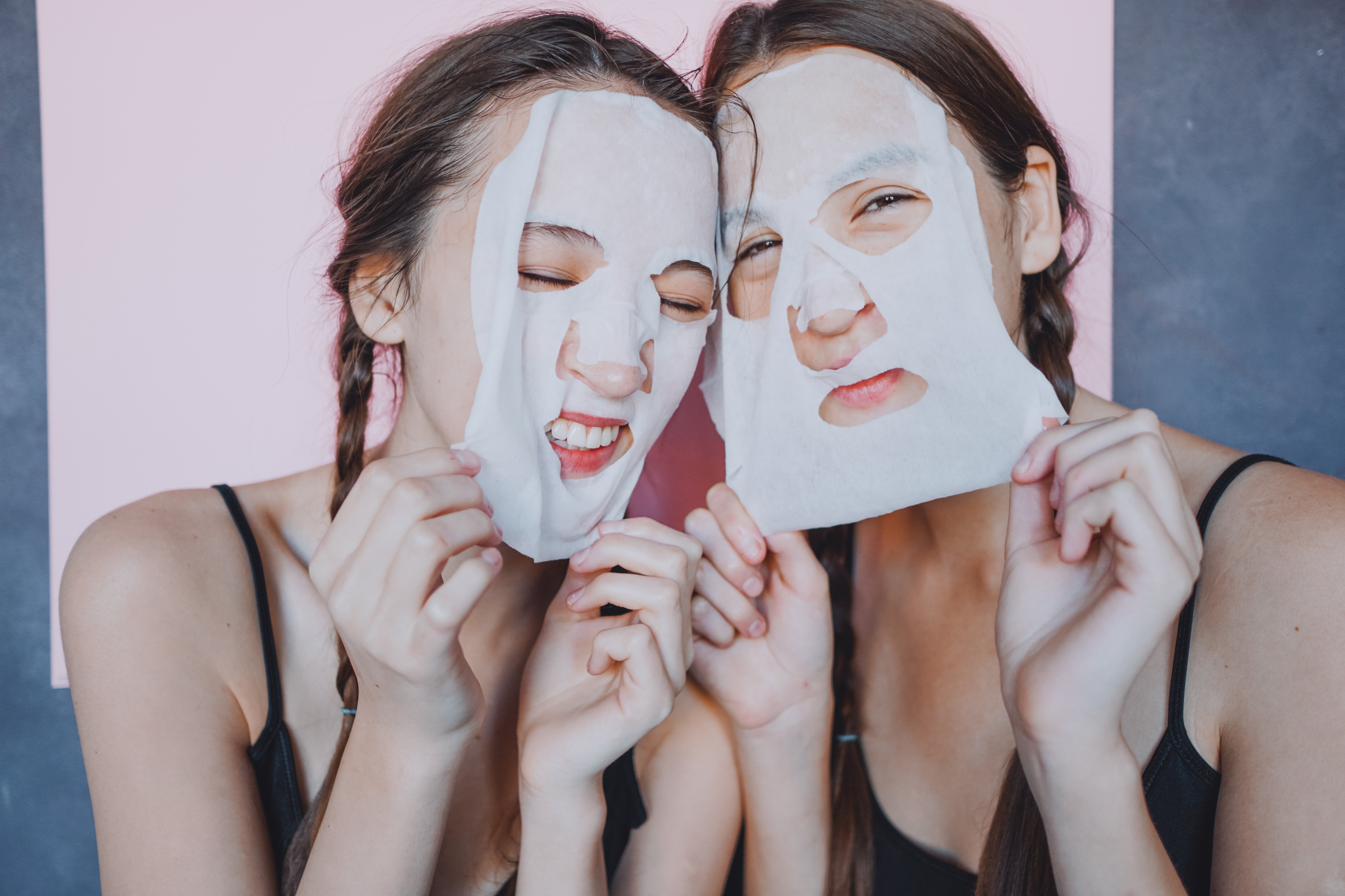 Canva - Young female twins with facial sheet masks
